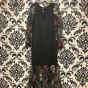 Black dress with mesh floral sleeves and bottom of the dress
